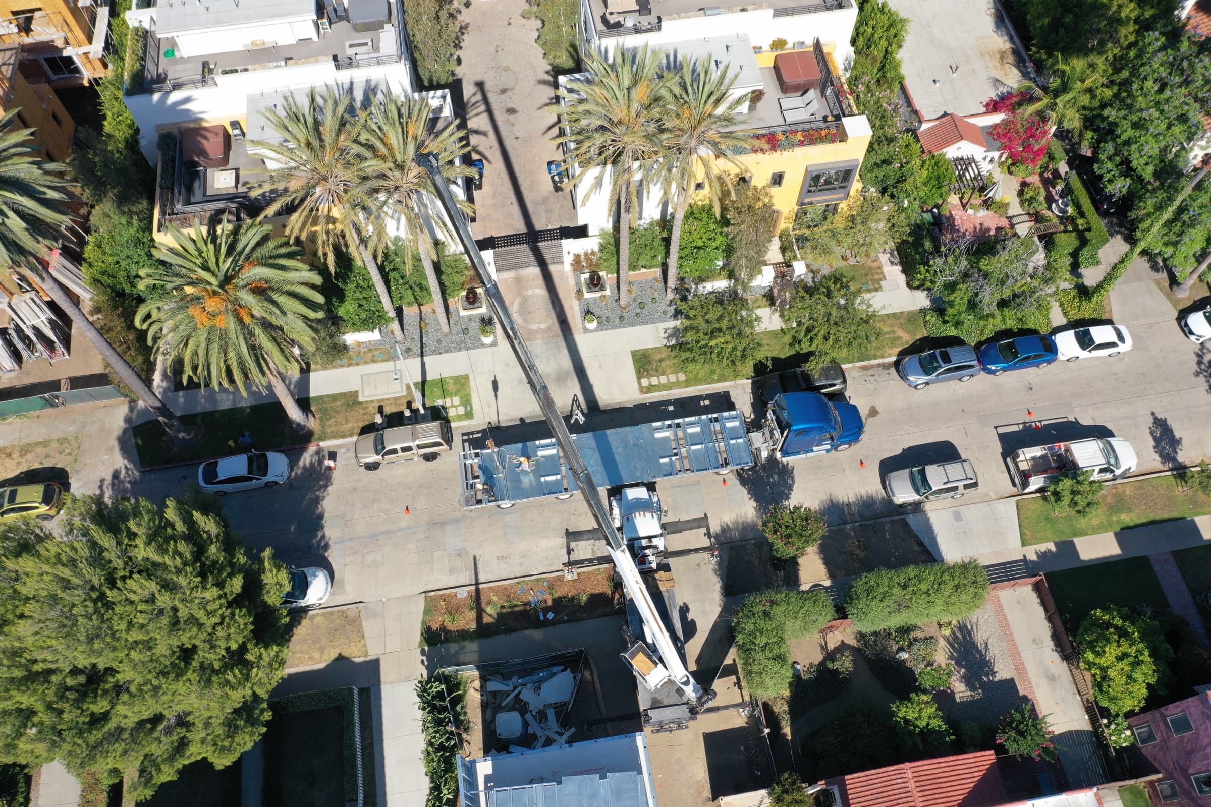 Aerial view of light-gauge steel wall panels being delivered to an ADU Concepts job site